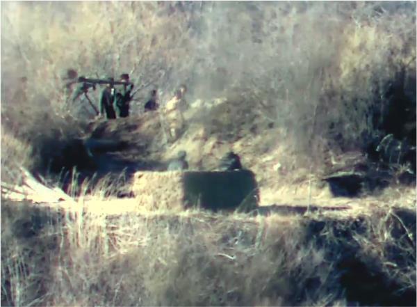 North Korean soldiers are spotted carrying heavy arms near a guard post inside of the Demilitarized Zone separating the two Koreas in this photo provided by the South Korean defense ministry on Nov. 27, 2023. (PHOTO NOT FOR SALE) (Yonhap) 