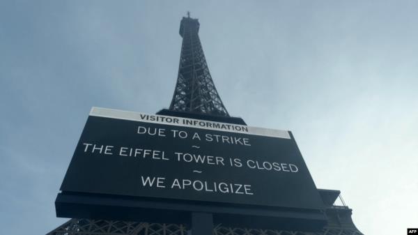 A board informs visitors that the site is closed after staff went on strike, at the bottom of the Eiffel Tower in Paris, Dec. 27, 2023.