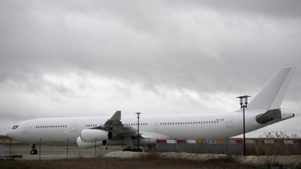 The plane reported to carry some 300 Indian citizens parks at the Vatry airport, eastern France, Saturday, Dec. 23, 2023 in Vatry. a<em></em>bout 300 Indian citizens heading to Central America were sequestered in a French airport for a third day Saturday because of an investigation into suspected human trafficking, authorities said. The 15 crew members of the Legend Airlines charter flight en route from United Arab Emirates to Nicaragua were questio<em></em>ned and released, according to a lawyer for the small Romania-ba<em></em>sed airline. (AP Photo/Christophe Ena)