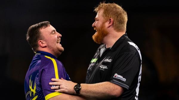 Luke Littler (left) shakes hands with Matt Campbell after winning their match on day ten of the Paddy Power World Darts Champio<em></em>nship at Alexandra Palace, London. Picture date: Wednesday December 27, 2023. PA Photo. See PA story DARTS World. Photo credit should read: Steven Paston/PA Wire.....RESTRICTIONS: Use subject to restrictions. Editorial use only, no commercial use without prior co<em></em>nsent from rights holder.  