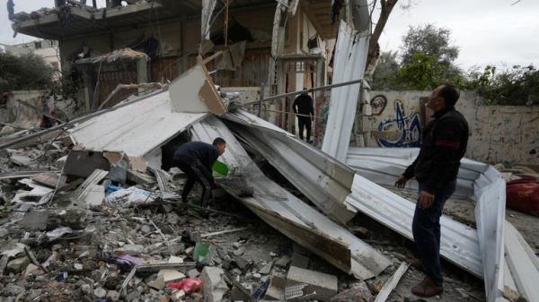 Gazans search the rubble after an attack on the Nuseirat refugee camp