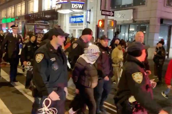 Police arresting a demo<em></em>nstrator in Manhattan on Christmas Day.