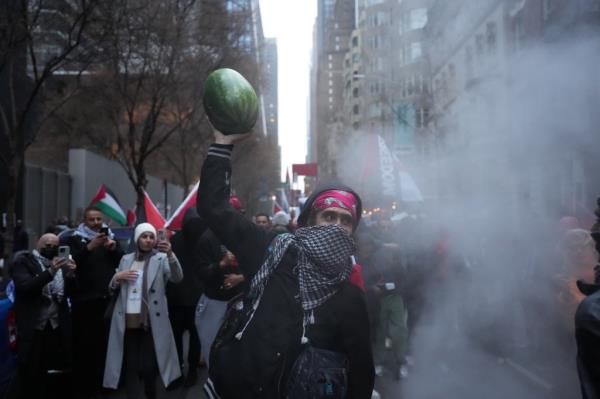 A demo<em></em>nstrator holding up a watermelon during the Manhattan protest.