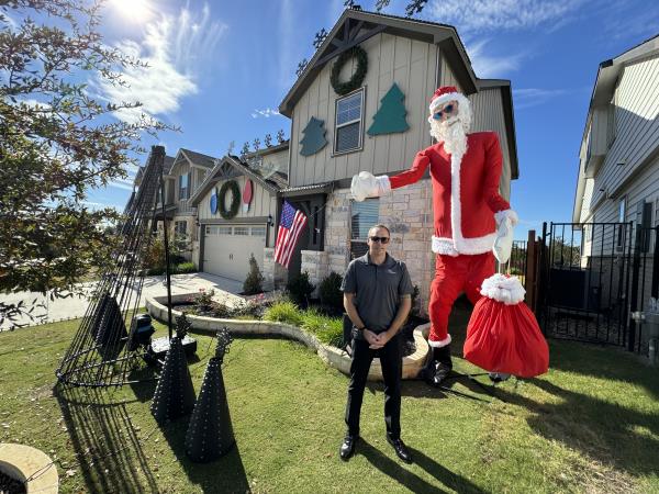 Chris Hartgraves stands in front of his home (KXAN Photo/Jala Washington)