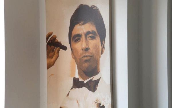 Pictured is the Scarface poster of Al Pacino's villainous character Tony Mo<em></em>ntana owned by one of the gang's members