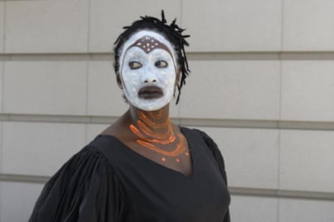 A black French-African woman, comedian Nathalie Vairac, in white face for an art installation.