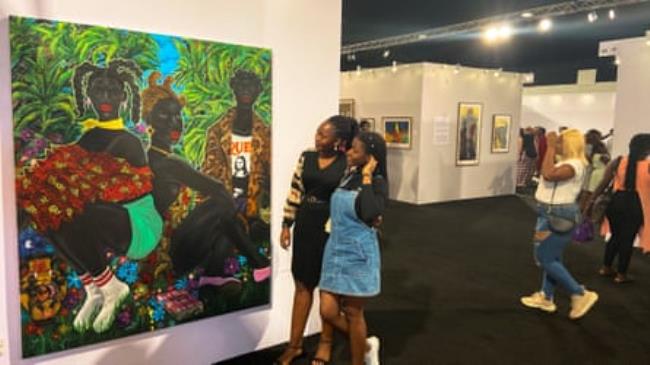 African audience admiring the art on show at Art X Lagos 2022.