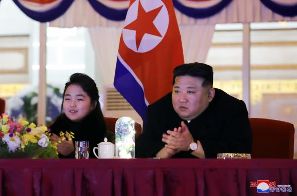 North Korean leader Kim Jong-un (right), alo<em></em>ngside his daughter Ju-ae, applauds as he watches an art performance in a New Year’s celebration at the May Day Stadium in Pyongyang, in this undated photo released by the North’s official Korean Central News Agency on Monday. (Yonhap-KCNA)