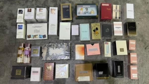 Over S$2 million worth of counterfeit perfume, candles and diffusers seized; man arrested