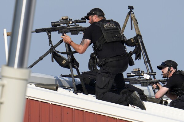 Police snipers return fire after shots were fired while Republican presidential candidate former President Do<em></em>nald Trump was speaking at a campaign event in Butler, Pa., on Saturday, July 13, 2024. (AP Photo/Gene J. Puskar)