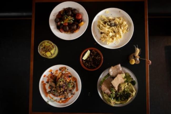 A selection of small plate dishes on a black tray