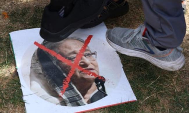 A picture of a woman with a red cross through her face and three feet stepping on it. 