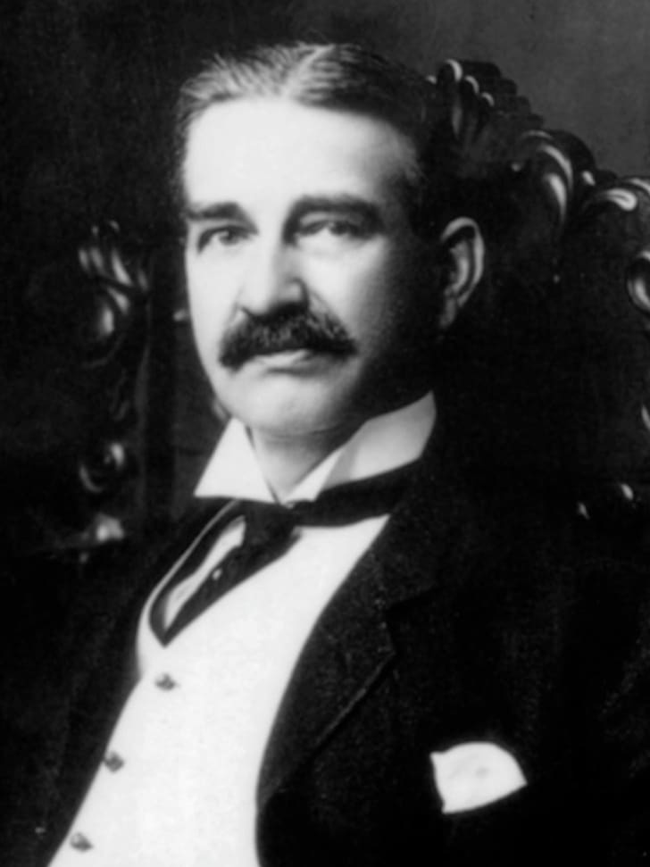 black and white portrait of a mustachioed middle-aged man