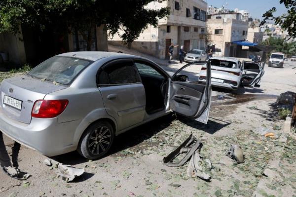 A view of vehicles damaged in an Israeli airstrike, in Jenin, in the Israeli-occupied West Bank