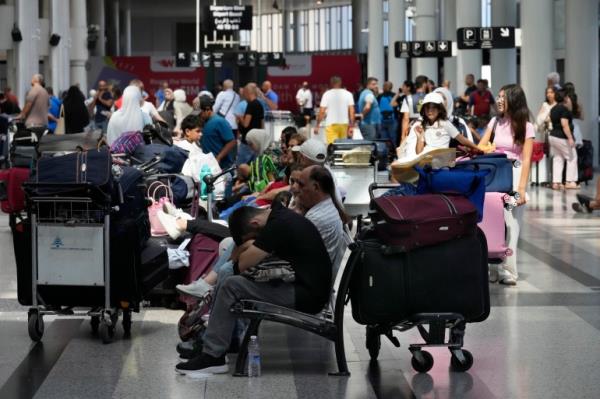 Passengers whose flights were cancelled, wait at the departure terminal of Rafik Hariri Internatio<em></em>nal Airport