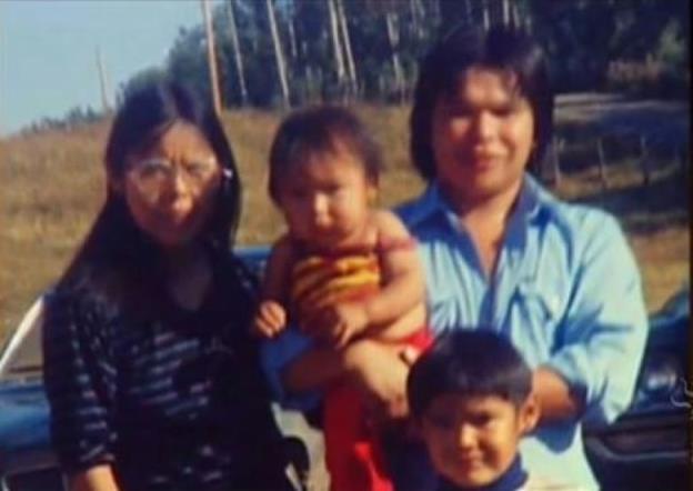 A family poses in a photo.