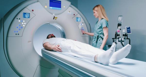 A man a<em></em>bout to enter an MRI machine