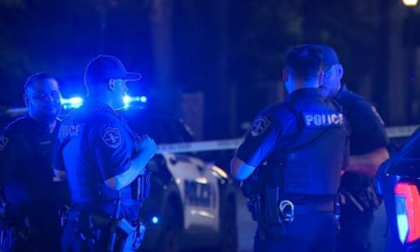 a group of police officer standing around with blue light on them 