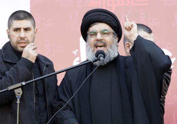 Hezbollah leader Hassan Nasrallah speaks to the crowd in a rare public appearance during a rally to mark the Muslim holy day of Ashoura, in Beirut's southern suburbs, Tuesday Dec. 6, 2011. Picture: AP Photo/Bilal Hussein, File