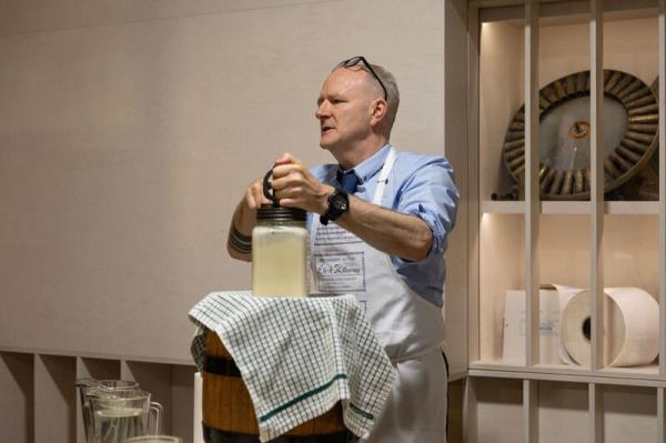 Dominic Moore demo<em></em>nstrating how butter was made on a tour of the Butter Museum.