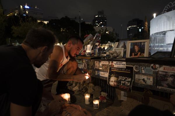 People light candles at a memorial for the victims of the Oct.ober 7 Hamas cross-border attack on Israel, on the eve of the one-year anniversary of the attack, in Tel Aviv, Israel, Sunday, October 6, 2024. 