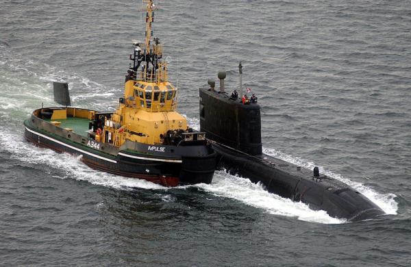 HMCS Chicoutimi, the Canadian submarine, being brought into the Clyde in the last stages of its journey to the Clyde Submarine ba<em></em>se in October 2004. The submarine was assisted into port by a UK and Canadian frigate, and several smaller vessels. File photo: Royal Navy/Ian Arthur