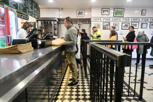 Robert Ryan collecting his order from Frances Lennox at the Jackie Lennox's chip shop on the Bandon, Cork which will close its doors to the public on Sunday. Picture: Dan Linehan