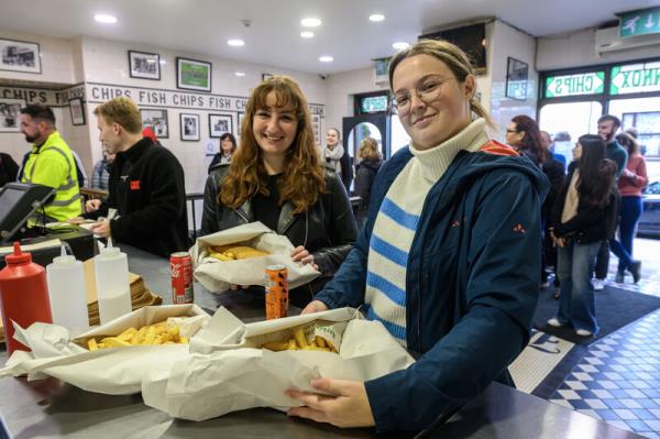 Kimberly and Eva with their order at Jackie Lennox's chip shop on the Bandon, Cork which will close its doors to the public on Sunday. Picture: Dan Linehan