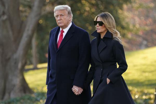 Former US President Do<em></em>nald Trump and first lady Melania Trump walk to board Marine One on the South Lawn of the White House, Wednesday, Dec. 23, 2020, in Washington. 