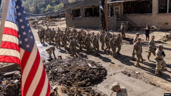 Army soldiers from 1st Battalion, 502nd Infantry Regiment, 101st Airborne Division arrive in Marshall, North Carolina, to help residents to clean up after Hurricane Helene, Oct. 8, 2024. 