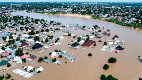 FILE - Houses and other buildings are partially submerged following a dam collapse in Maiduguri, Borno state, Nigeria, on Sept 10, 2024. Health officials say flooding has created ideal co<em></em>nditions for the spread of cholera.