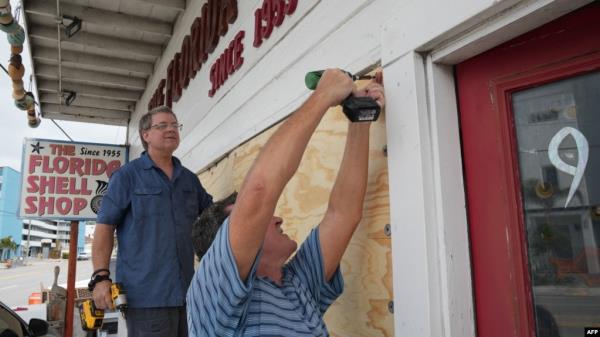 Residents board up a sea shell store ahead of Hurricane Milton’s expected landfall in the middle of this week in Treasure Island, Florida on October 7, 2024.