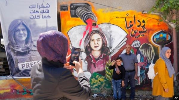 FILE - Palestinians visit the site wher<em></em>e Al Jazeera journalist Shireen Abu Akleh was shot and killed, in the West Bank city of Jenin, May 18, 2022.