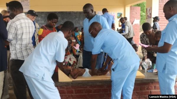 Health workers in Malawi's Chikwawa district prepare a baby for a malnutrition test on Oct. 2, 2024.