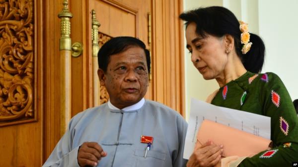 FILE - Zaw Myint Maung, left, an impriso<em></em>ned politician and a close colleague of Myanmar’s ousted leader Aung San Suu Kyi, right, talks with Suu Kyi at Parliament in Naypyitaw, July 23, 2015.