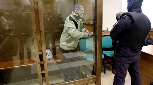 In this photo released by the Moscow City Court Press Service, Stephen Hubbard, a U.S. citizen accused of fighting as a mercenary in Ukraine stands in a glass cage during a court session in Moscow, Oct. 7, 2024.