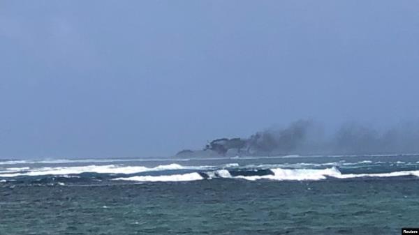 A view of a New Zealand Navy vessel on fire, as seen from Tafitoala, Samoa, Oct. 6, 2024, in this picture obtained from social media. (Dave Poole/via Reuters)