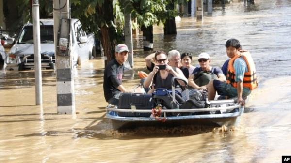 Tourists leave a flood-hit area in Chiang Mai Province, Thailand, Oct. 5, 2024.