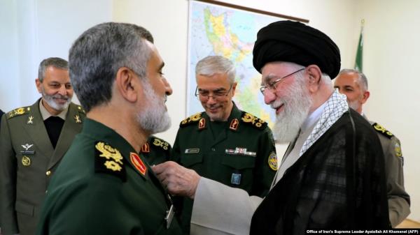 Iran's Supreme Leader Ayatollah Ali Khamenei (R) decorates, Oct. 6, 2024, the Islamic Revolutio<em></em>nary Guard Corps' Aerospace Force Commander Brigadier General Amir Ali Hajizadeh (L) with the 'Fath' badge in Tehran for planning the Iranian attack on Israel.