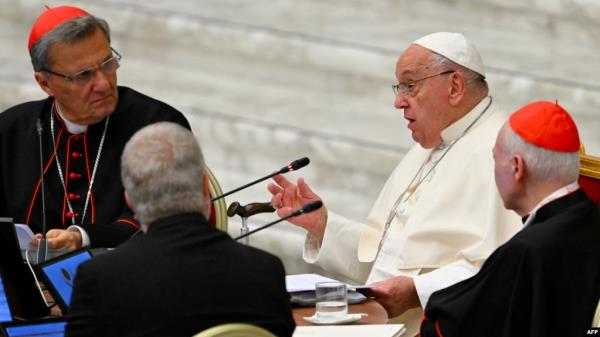 FILE - Maltese cardinal Mario Grech (L), Pope Francis (C) and cardinal Carlos Aguiar Retes attend the Second Session of the 16th Ordinary General Assembly of the Synod of Bishops at the Paul VI audience hall, in The Vatican, Oct. 2, 2024. 