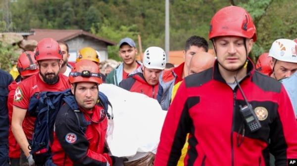 Members of the mountain rescue service carry a body of a person killed by a landslide in the flooded village of Do<em></em>nja Jablanica, Bosnia, Oct. 5, 2024.