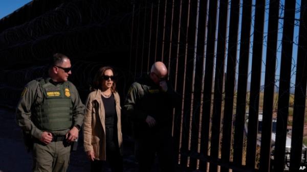 Vice President Kamala Harris talks with John Modlin of the US Border Patrol, right, and Blaine Bennett, US Border Patrol Douglas Station border patrol agent in charge, at the US border with Mexico in Douglas, Ariz., Sept. 27, 2024.