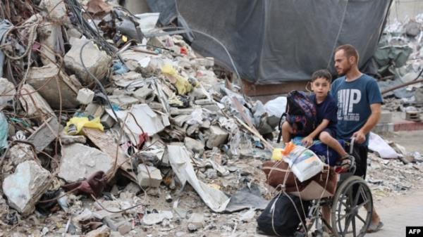 A Palestinian family arrives in Gaza City after evacuating their homes in the Jabalia area on Oct. 6, 2024, after the Israeli army ordered people to evacuate the area north of Gaza.