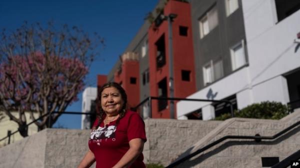 Marina Maalouf, who participated in protests after rents doubled in 2019, stands for a photo outside her apartment building in Los Angeles on Sept. 18, 2024.