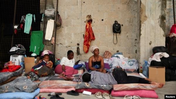 Women and a child from Sierra Leone rest at a shelter for displaced migrant workers, in Hazmieh, Lebanon, Oct. 5, 2024.