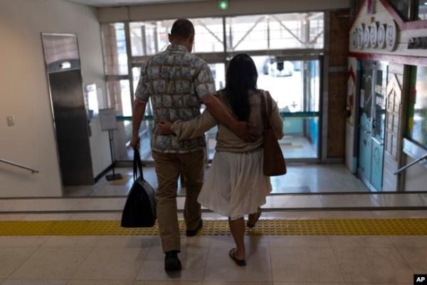 FILE - Kenneth Barthel, left, who was adopted to the United States at age 6, and his wife, Napela, comfort each other as they leave the Busan Metropolitan City Child Protection Center in Busan, South Korea, May 17, 2024, after searching for docu<em></em>ments related to his birth family.