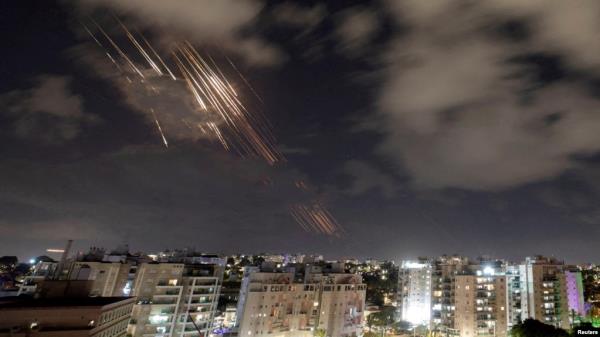 FILE - Israel's Iron Dome system intercepts ballistic missiles fired by Iran, as seen from Ashkelon, Israel, Oct. 1, 2024. Israel has not yet decided on how it will respond, U.S. President Joe Biden said on Oct. 4.