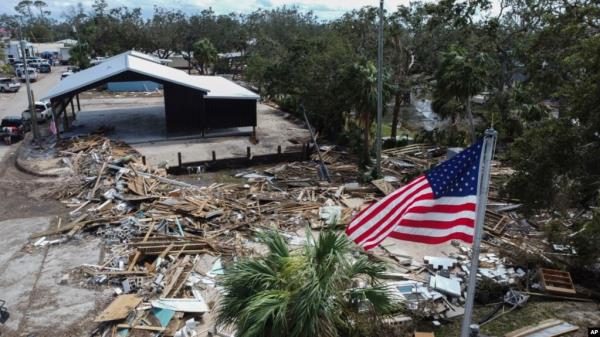 An American flag flies over the destroyed city hall in the aftermath of Hurricane Helene, in Horseshoe Beach, Florida, Sept. 28, 2024. 