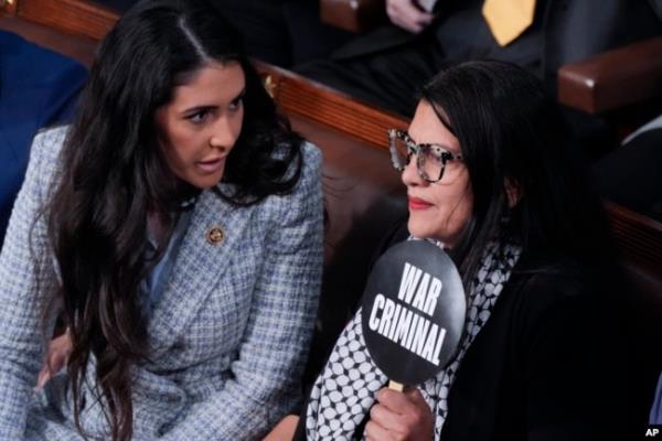 FILE - Rep. Anna Paulina Luna, R-Fla., talks to Rep. Rashida Tlaib, D-Mich., holding a sign, during a speech by Israel's prime minister in Washington, July 24, 2024. Arab, Palestinian and Muslim groups have protested U.S. support for Israel in the war against Hamas.