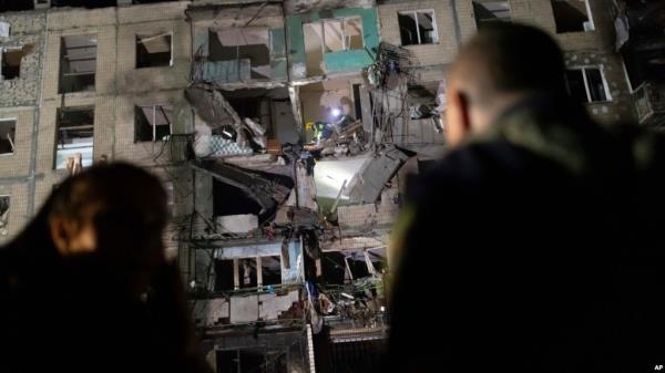 Rescue workers clear the rubble inside a building damaged by a Russian airstrike in Kharkiv, Ukraine, Oct. 3, 2024. 